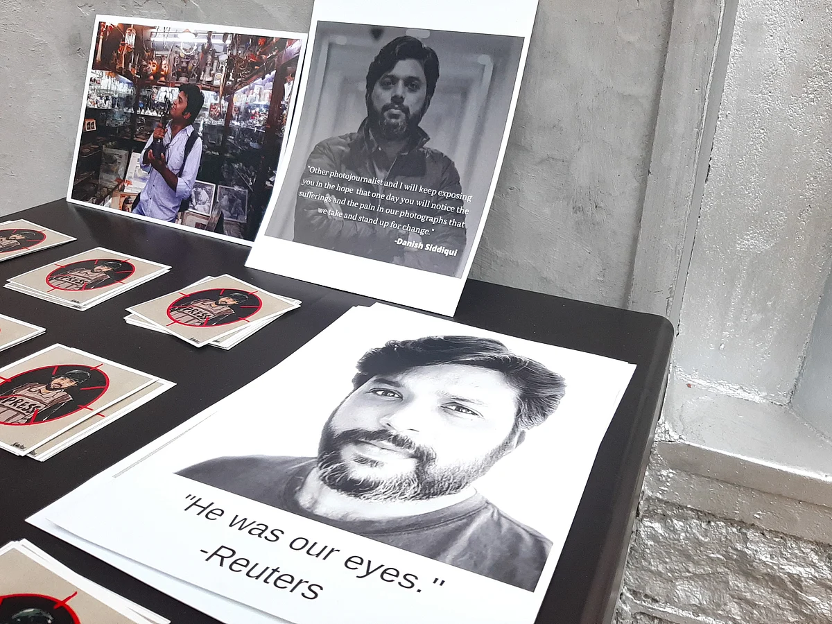 Photographs shot by Reuters photographer Danish Siddiqui are displayed along with his portrait inside the Kashmir Press Club as journalists light candles to pay tribute to him in Srinagar, Jammu & Kashmir on July 18, 2021.