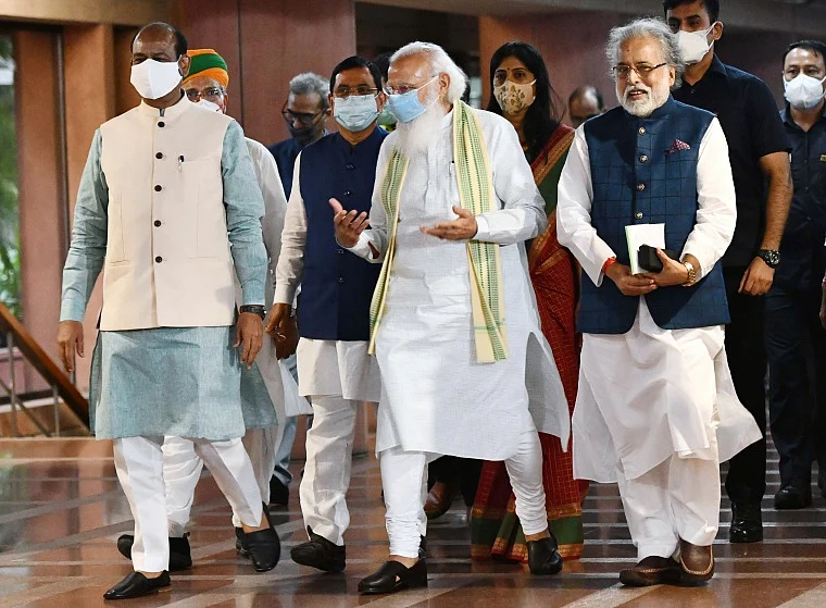 Prime Minister Narendra Modi with Lok Sabha Speaker Om Birla and TMC MP Sudip Bandyopadhyay after a meeting with leaders of the parties in Lok Sabha on the eve of monsoon session of Parliament, at Library building in New Delhi
