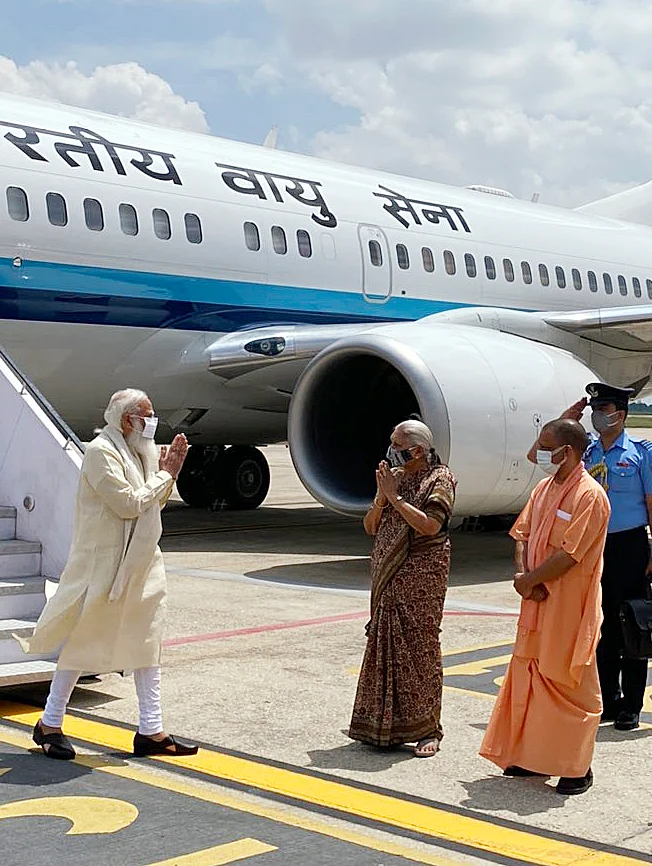 Prime Minister Narendra Modi being received at the airport by Uttar Pradesh Governor Anandiben Patel, CM Yogi Adityanath, and other dignitaries, in Varanasi on Thursday.