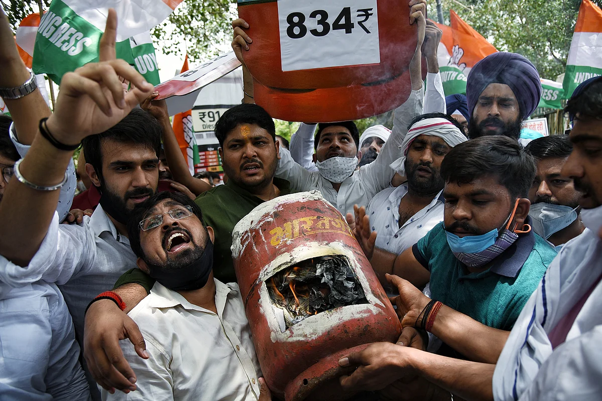 Indian Youth Congress (IYC) supporters stage a protest against the hike in fuel prices outside Shastri Bhawan, in New Delhi on Saturday.