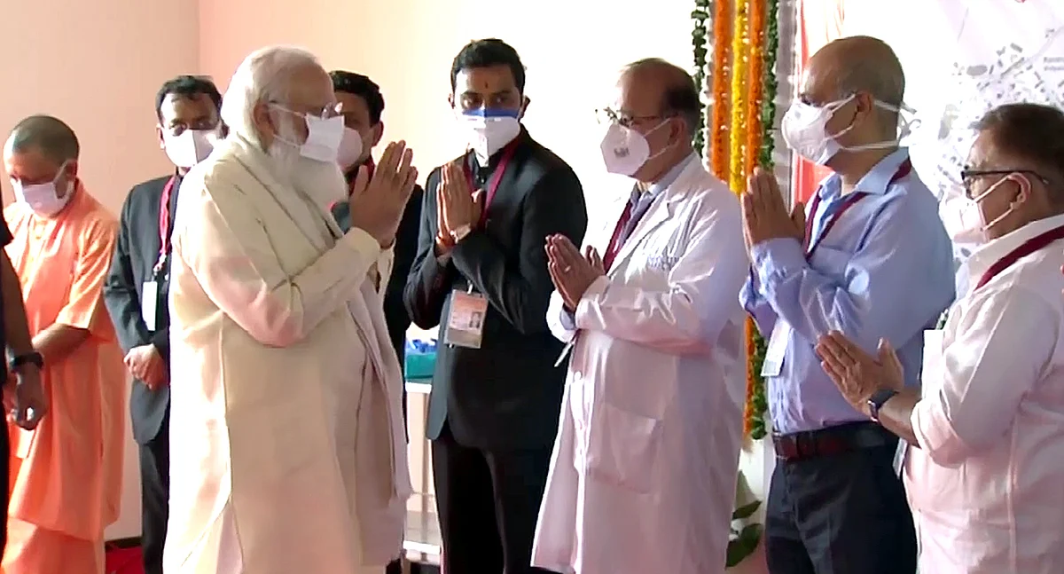 Prime Minister Narendra Modi greets the doctors during his visit to the 100-bed maternal & child health wing at Banaras Hindu University, in Varanasi on Thursday.