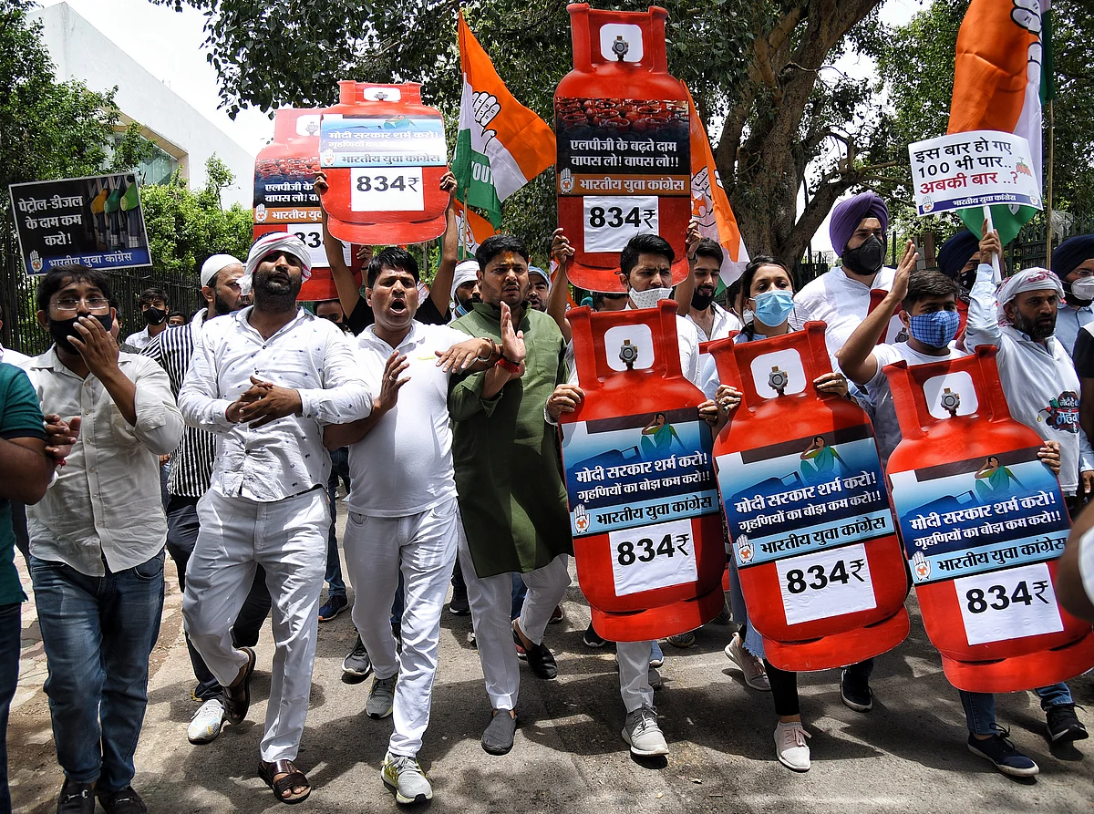 Indian Youth Congress (IYC) supporters hold placards and shout slogans during a protest against the hike in fuel prices outside Shastri Bhawan, in New Delhi on Saturday.