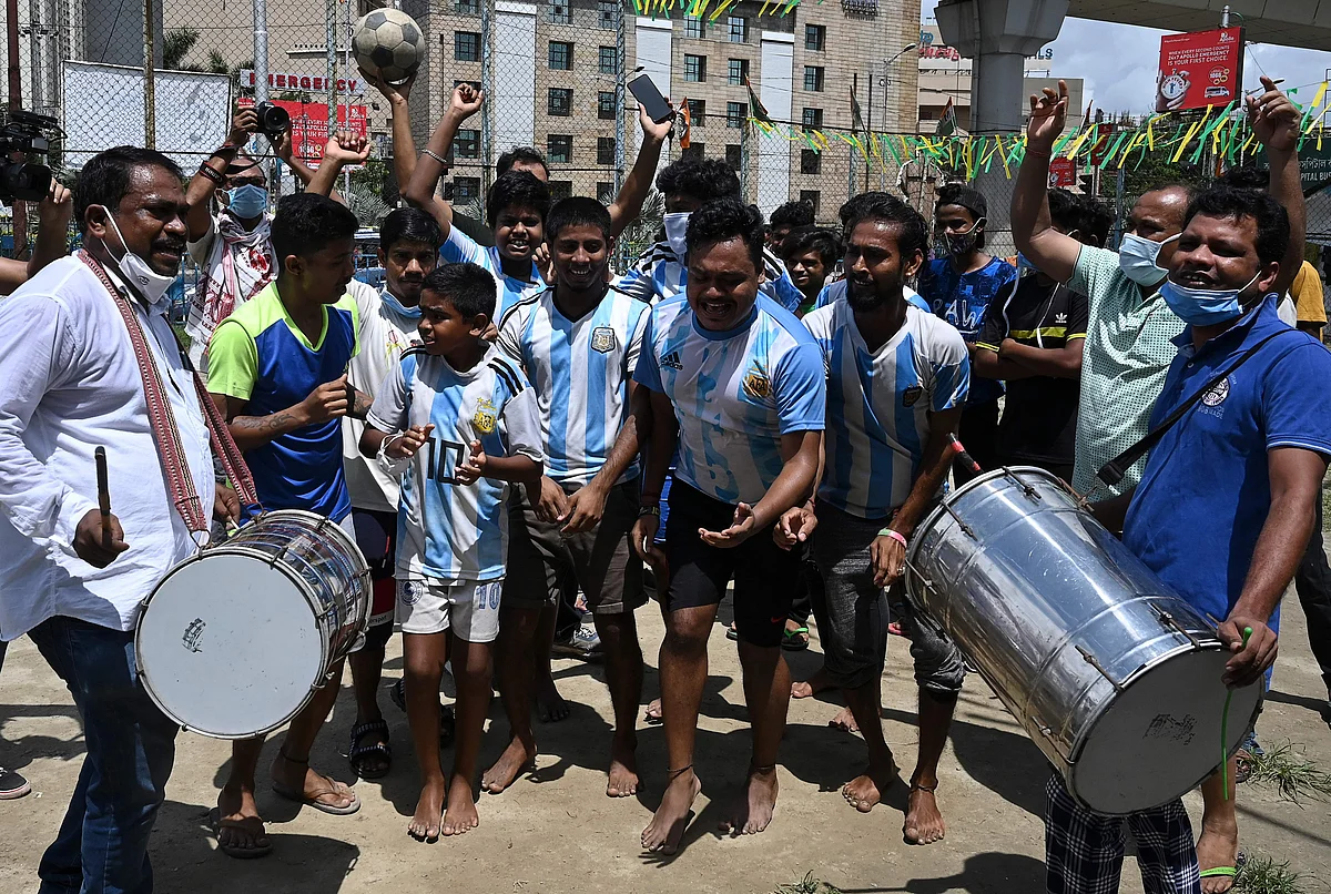 Argentina football fans celebrate after winning the Conmebol 2021 Copa America football tournament final match against Brazil, in Kolkata on July 11, 2021.