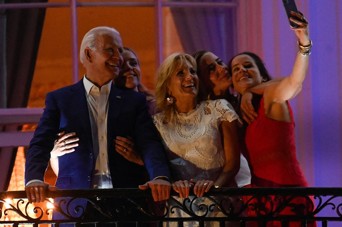 US President Joe Biden (L), First Lady Jill Biden (C), daughter Ashley Biden (R) and granddaughters Finnegan Biden (2nd L) and Naomi Biden pose for a selfie during Independence Day celebrations at the White House in Washington, DC, July 4, 2021.