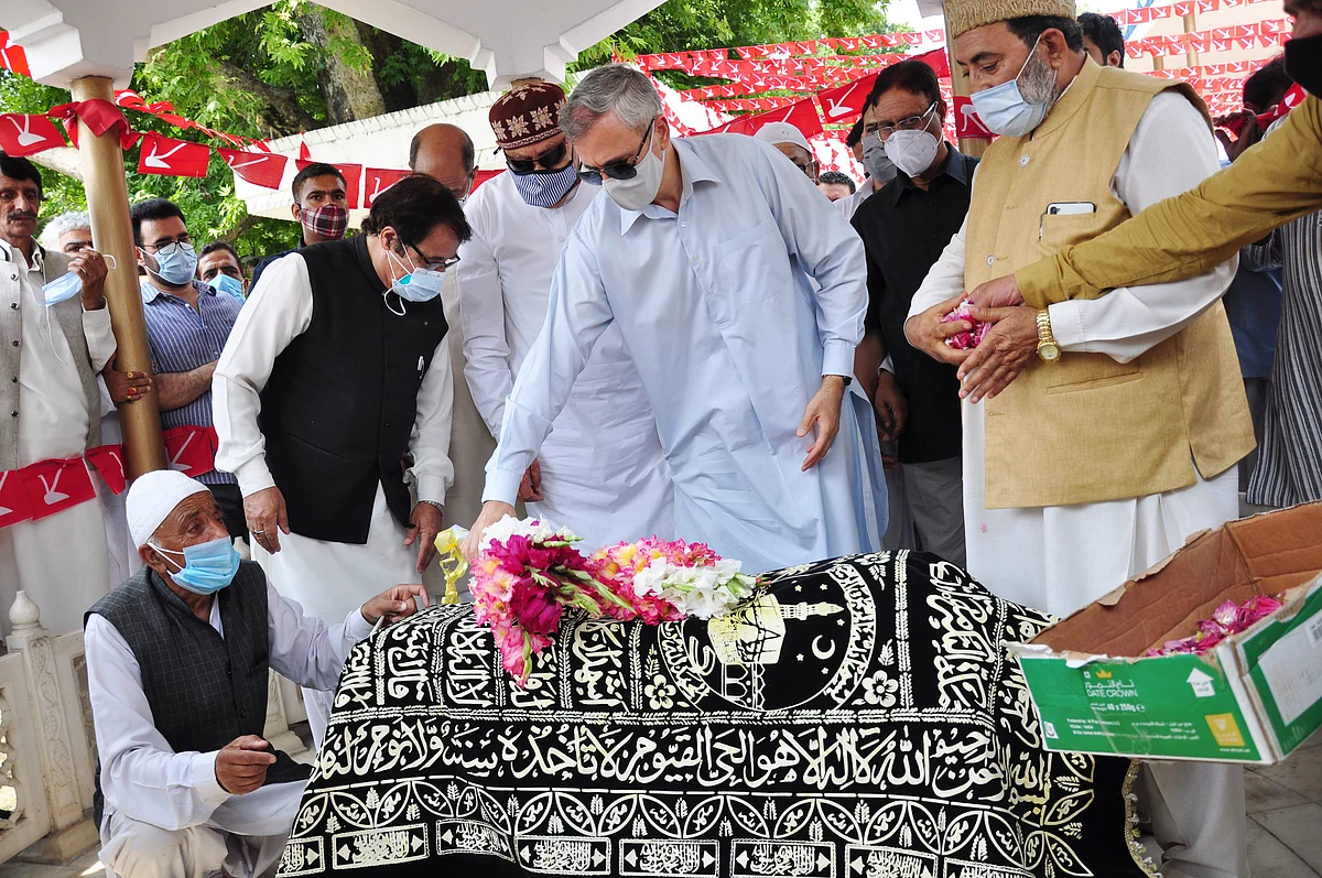 Jammu and Kashmir National Conference President and MP Dr. Farooq Abdullah, son Omar Abdullah, and senior party leaders pay tributes to Begum Akbar Jehan, MP and wife of JKNC founder Sheikh Muhammad Abdullah on her 21st death anniversary at her grave Hazratbal in Srinagar on Sunday, July 11,2021.