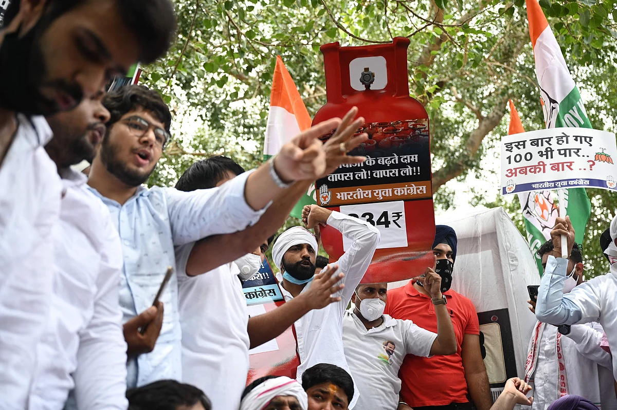 Activists of the Indian Youth Congress (IYC) party hold Liquefied Petroleum Gas (LPG) cylinders cutouts and placards while shouting slogans during a protest against the recent price hike of fuel and LPG, outside the ministry of petroleum and natural gas in New Delhi on July 3, 2021.