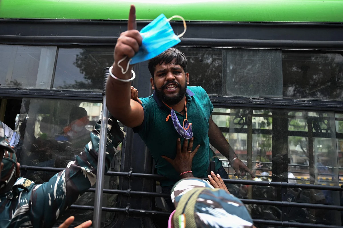 An activist of the Indian Youth Congress (IYC) party shouts slogans after being detained by police during a protest against the recent price hike of fuel and Liquefied Petroleum Gas (LPG) cylinder, outside the ministry of petroleum and natural gas in New Delhi on July 3, 2021