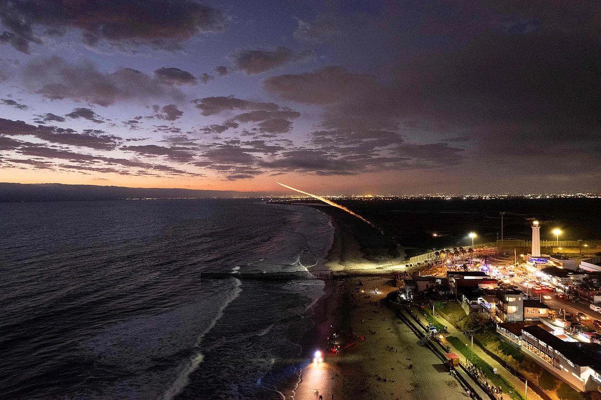 An aerial view shows people gathering on the Mexican side of the US-Mexico border to watch the Independence Day fireworks being shot on the other side on the San Diego Bay, from Playas de Tijuana, Baja California state on July 4, 2021.