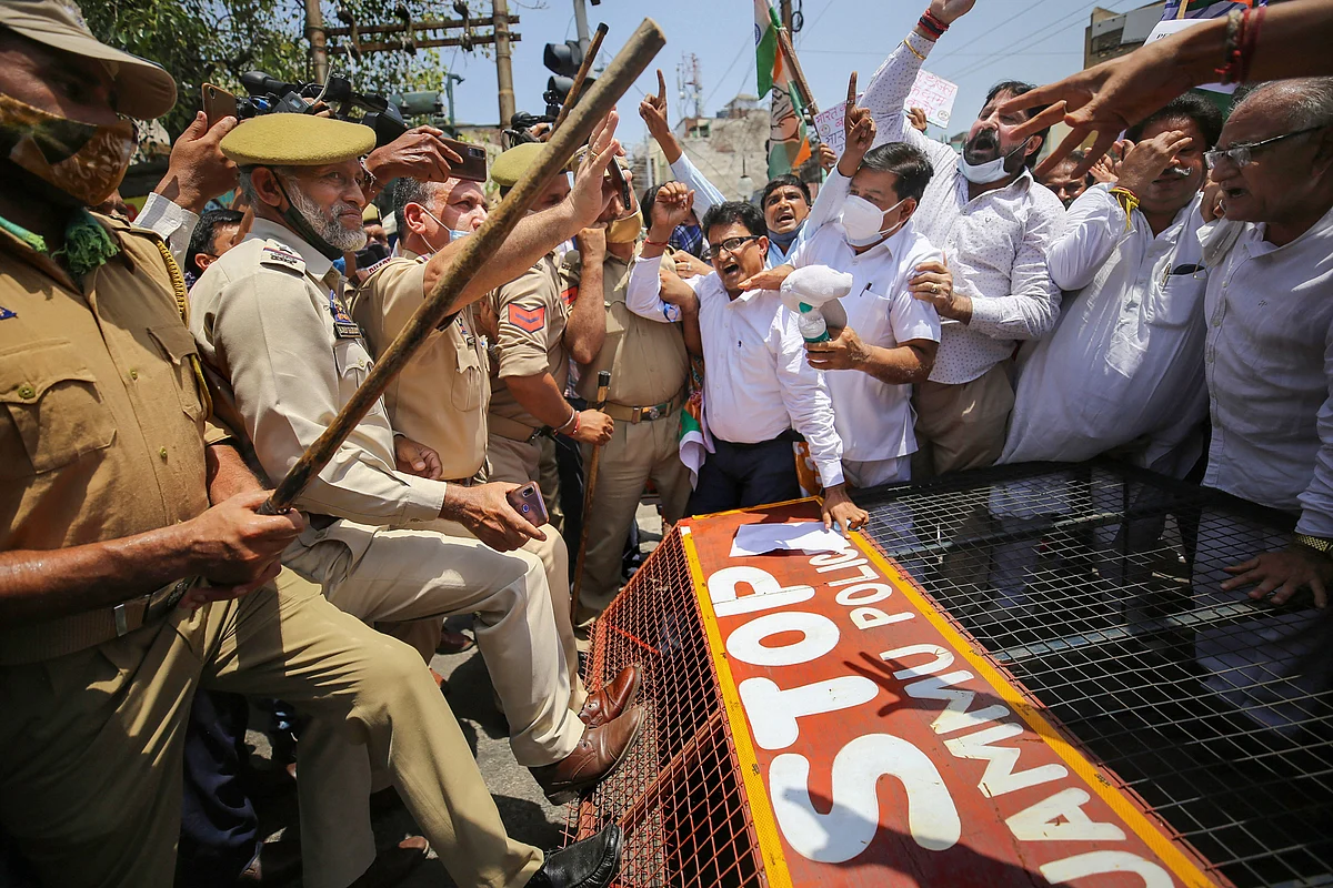 Police stop Congress workers who were staging a protest demanding for restoration of statehood to J & K, and against hike in the fuel prices, in Jammu, Wednesday, July 7, 2021.