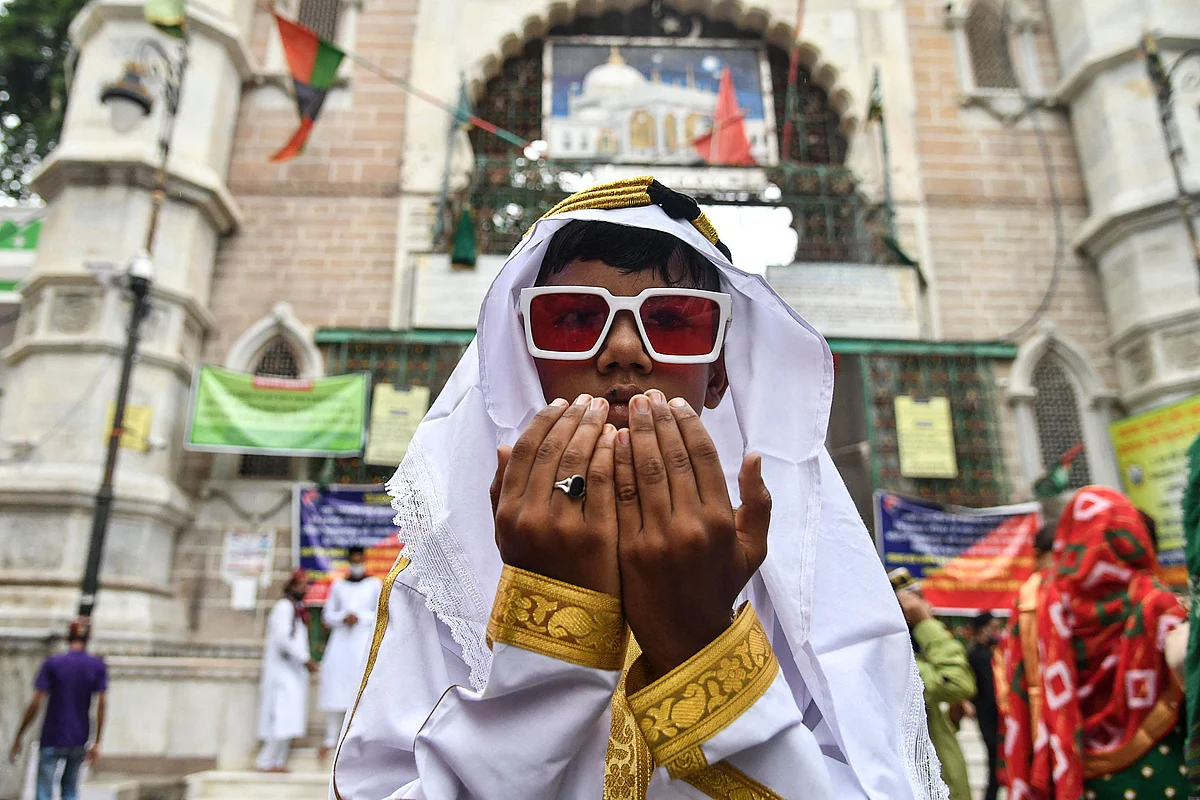 A young Muslim devotee offers prayers during the Eid al-Adha or the Festival of Sacrifice, in Ajmer on July 21, 2021.