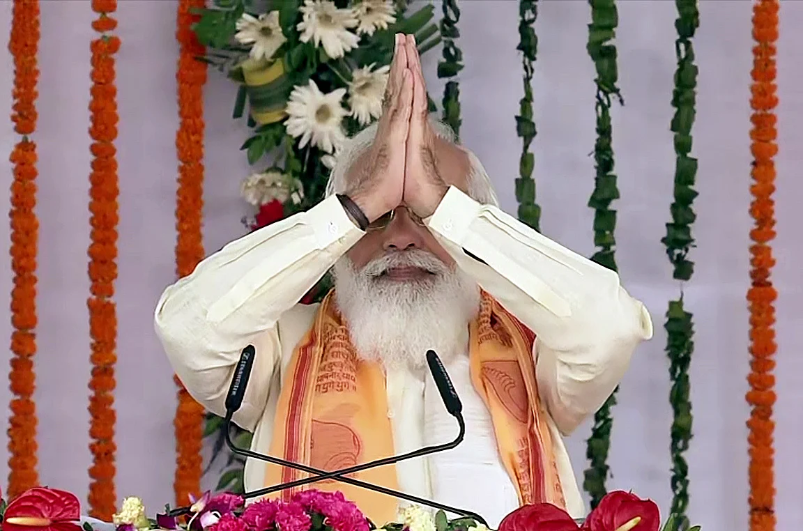 Prime Minister Narendra Modi greets during the foundation stone laying ceremony of multiple development projects, in Varanasi on Thursday.