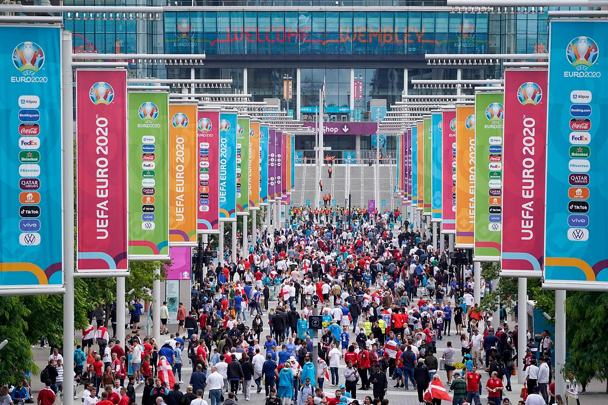 England supporters arrive to watch the UEFA EURO 2020 semi-final football match between England and Denmark at Wembley Stadium in London on July 7, 2021.