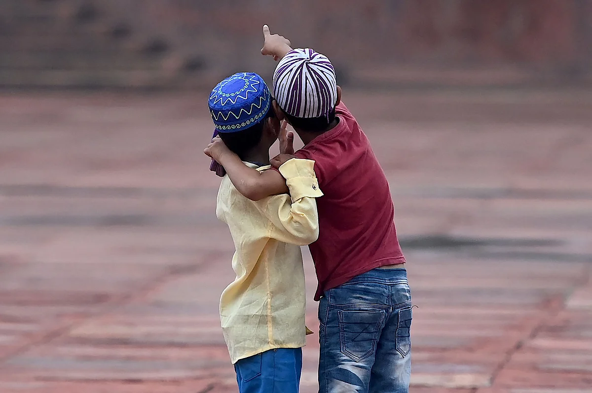 Children play after offering prayers during the Eid al-Adha festival, the feast of sacrifice at the Jama Masjid in New Delhi on July 21, 2021.