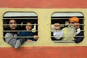 Passengers travel on a local train at the railway station in Amritsar on Tuesday
