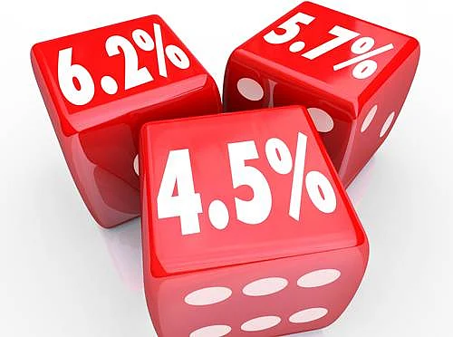Interest rate numbers and percentages on three red dice to advertise special low rates on financing debt or credit cards
