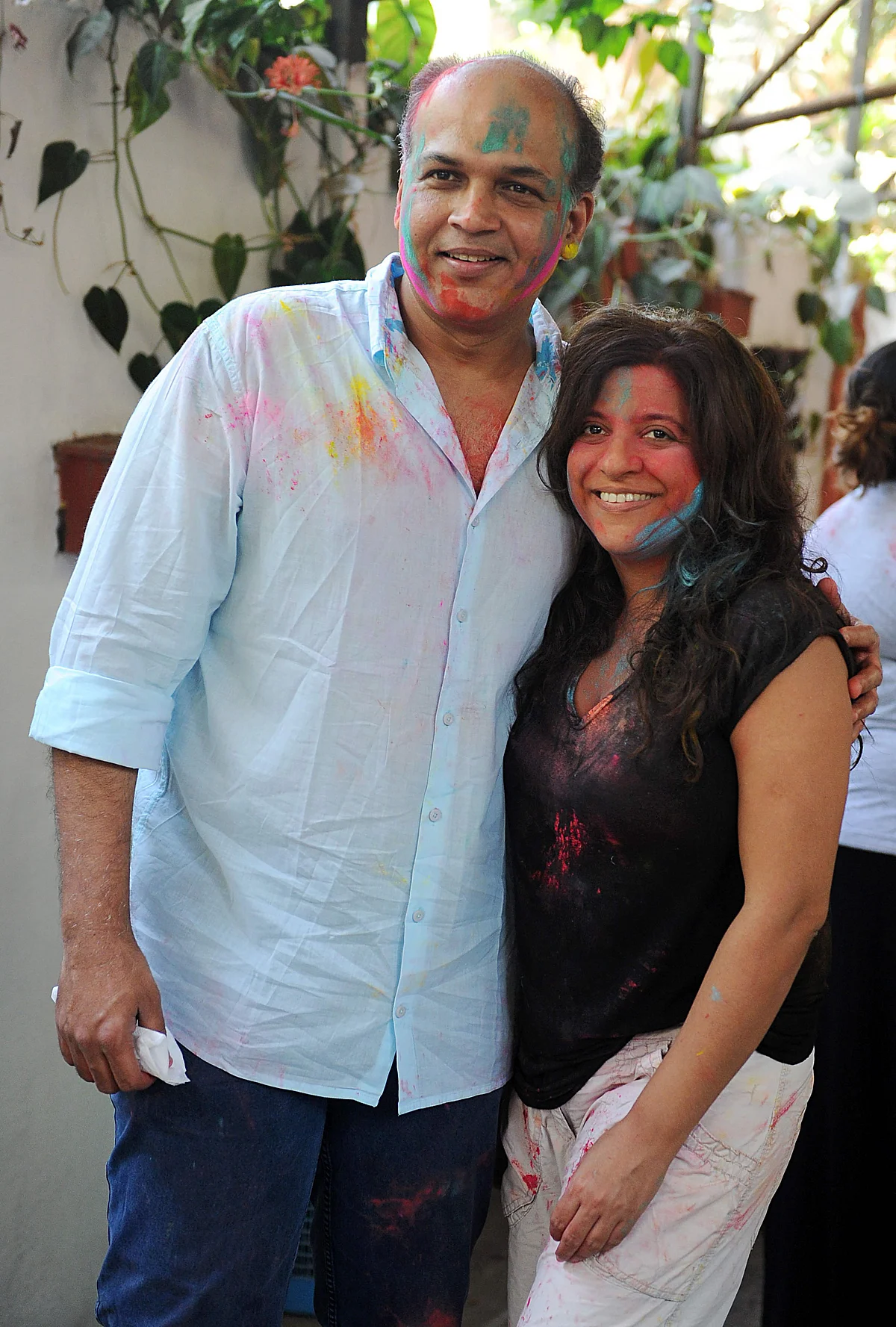 Indian Bollywood film directors Ashutosh Gowariker (L) and Zoya Akhtar (R) take part in celebrations to mark the Hindu festival of Holi in Mumbai