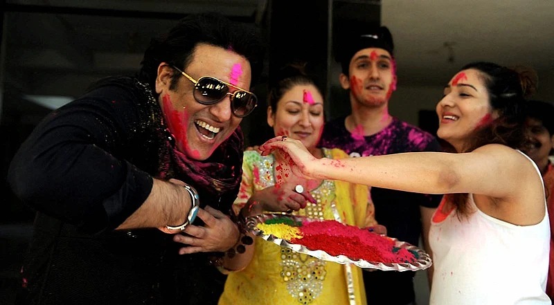 Bollywood actor Govinda with his wife Sunita Ahuja, daughter Tina Ahuja and son Yashvardan celebrating Holi festival in Mumbai on Monday.