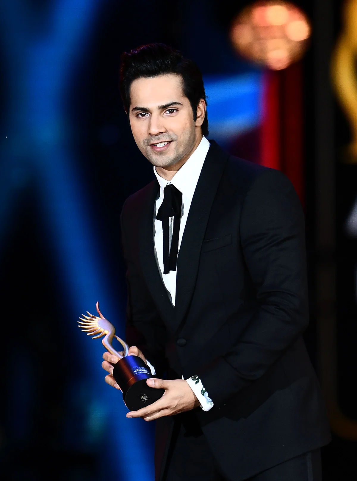 Winner of Performance in a Comic Role, Varun Dhawan (L) for “Dishoom” accepts the award during the 18th International Indian Film Academy (IIFA) Festival at the MetLife Stadium in East Rutherford, New Jersey, on July 15, 2017. / AFP PHOTO / JEWEL SAMAD