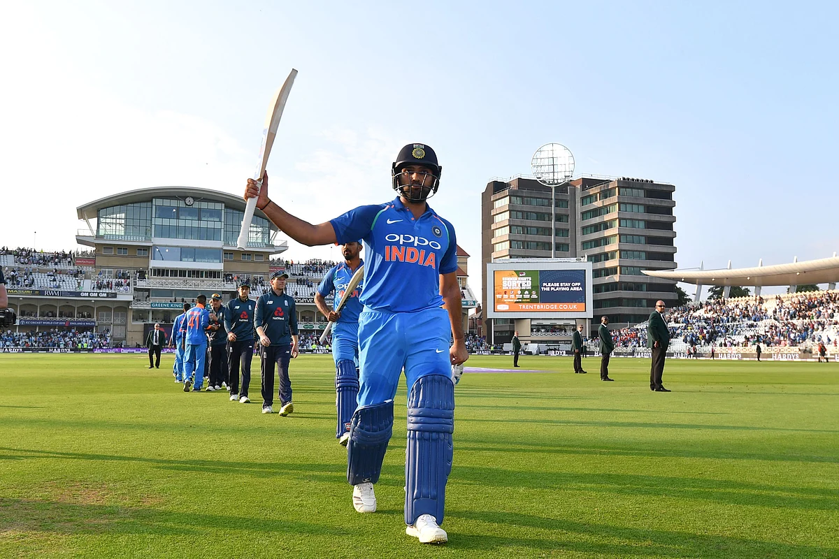 India’s Rohit Sharma raises his bat to acknowledge the crowd as he leaves the field after India won the One Day International (ODI) cricket match between England and India at Trent Bridge in Nottingham central England on July 12, 2018. / AFP PHOTO / Anthony Devlin