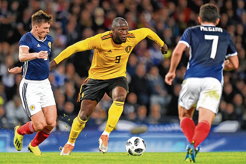 Belgium's striker Romelu Lukaku vies with Scotland's defender Kieran Tierney (L) and Scotland's midfielder John McGinn (R) during the International friendly football match between Scotland and Belgium at Hampden Park in Glasgow, Scotland on September 7, 2018. (Photo by Andy BUCHANAN / AFP)