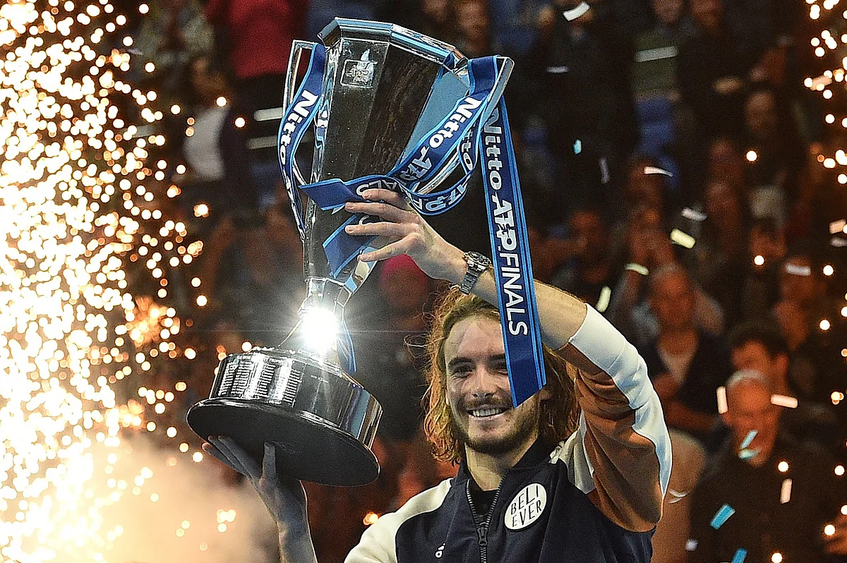 Stefanos Tsitsipas holds up the ATP Finals trophy.