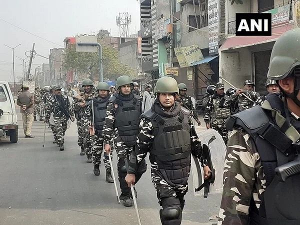Delhi violence: Security personnel conduct flag march with riot gears and batons in Babarpur