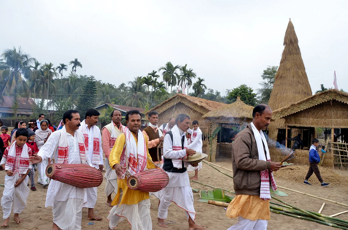 Villagers perform traditional ritual before the burning of the traditional Velaghor (Meji) on the occasion of Bhogali Bihu & Makar Sankranti in Tezpur on Thursday.