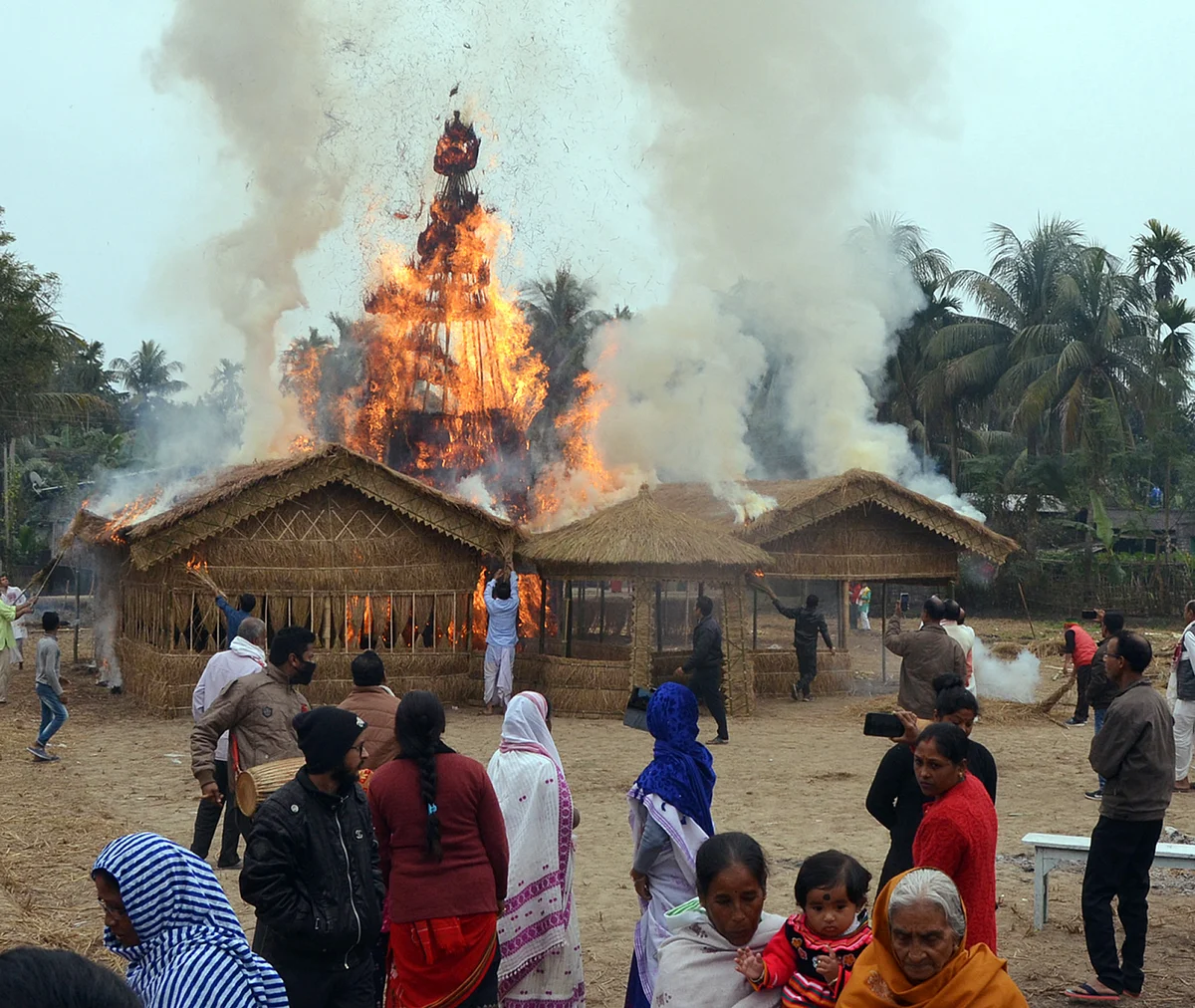 Assam, Jan 14 (ANI): Villagers watching the burning of the traditional Velaghor (Meji) on the occasion of Bhogali Bihu & Makar Sankranti in Tezpur on Thursday. (ANI Photo)