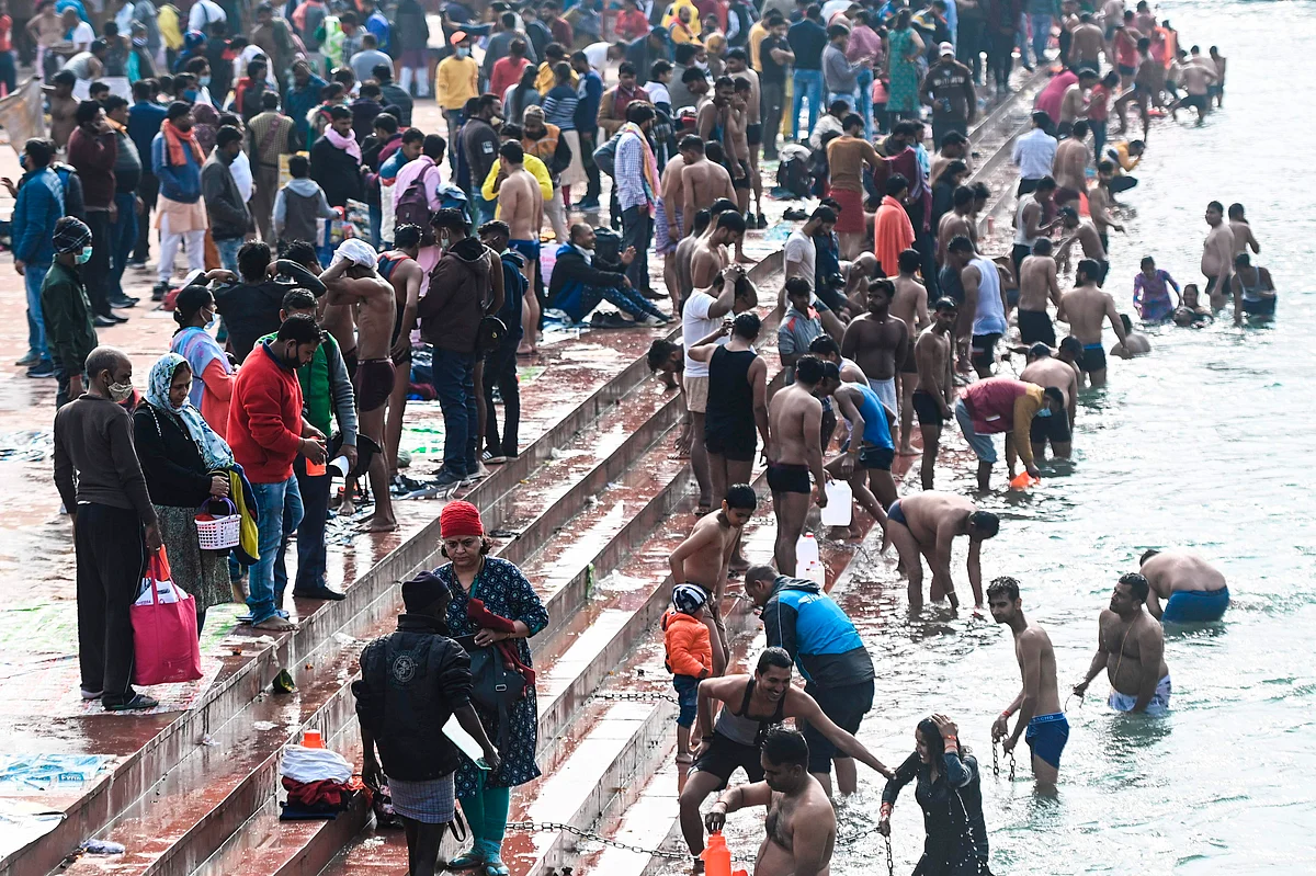 Hindu devotees take a holy dip in the waters of the River Ganges during Makar Sankranti, a day considered to be of great religious significance in the Hindu mythology, on the first day of the religious Kumbh Mela festival in Haridwar on January 14, 2021.