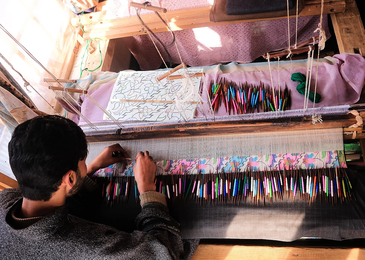 Kashmiri artisan weaves Kani Shawl, woven from Pashmina yarn, at a village in Budgam district in West Srinagar city.