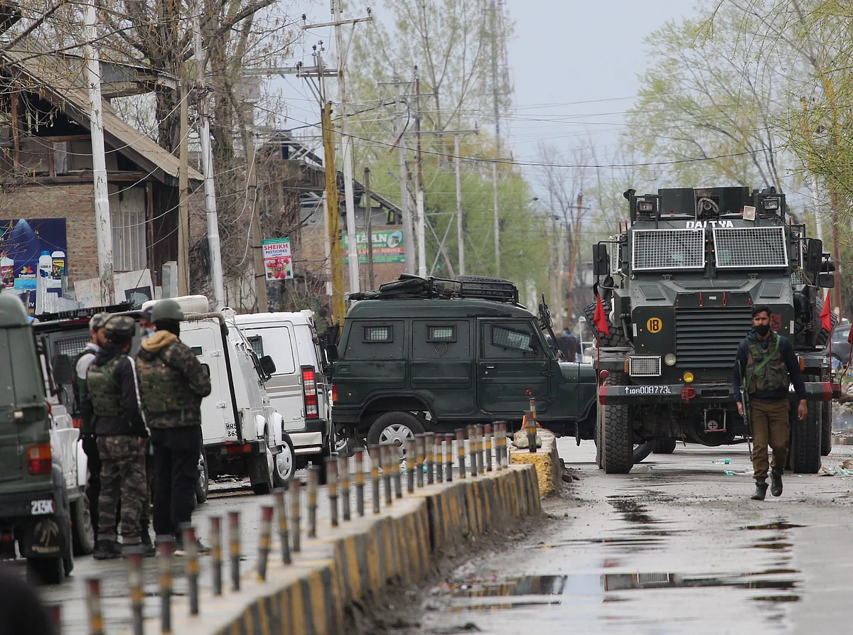 Paramilitary troopers are seen near the site of an attack by suspected militants on Municipal Councillor, at Sopore in North Kashmir.