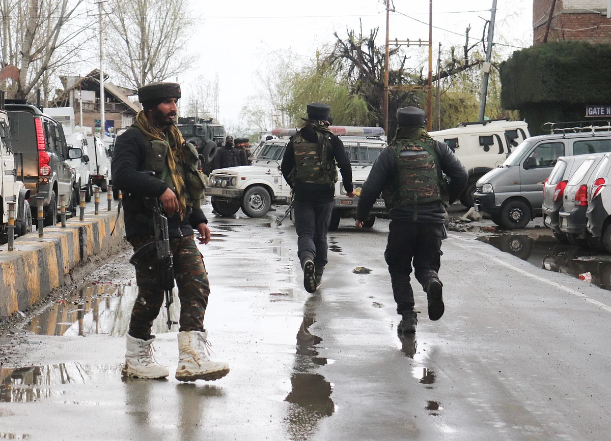 Army men rush near the spot of the militant attack in the Sopore area of Jammu and Kashmir.