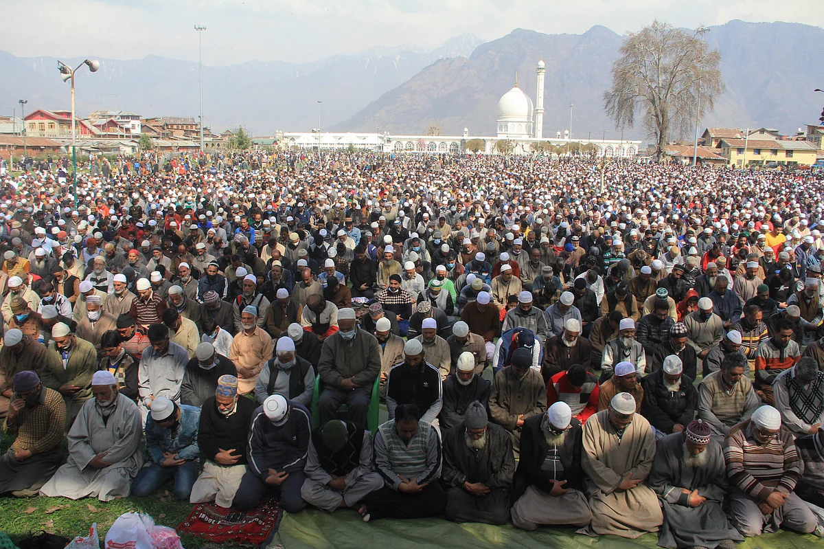 Kashmiri Muslims react upon seeing a relic believed to be a hair from the beard of Prophet Mohammed, being displayed on Friday following Meeraj-un-Nabi, a festival which marks the ascension of Prophet Mohammed to Heaven, at the Hazratbal shrine in Srinagar.