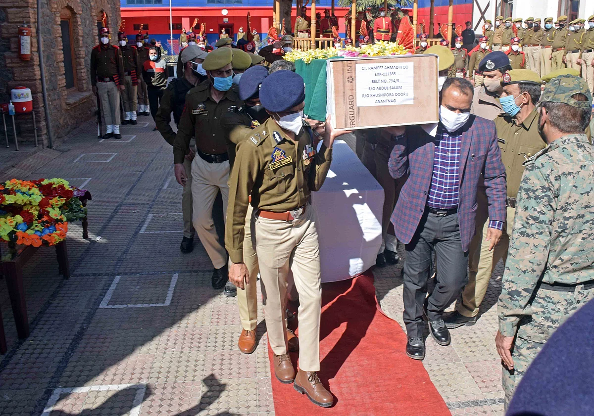 Senior police officers carry a coffin containing the body of the slain policeman during the wreath-laying ceremony at the police headquarters in Srinagar.