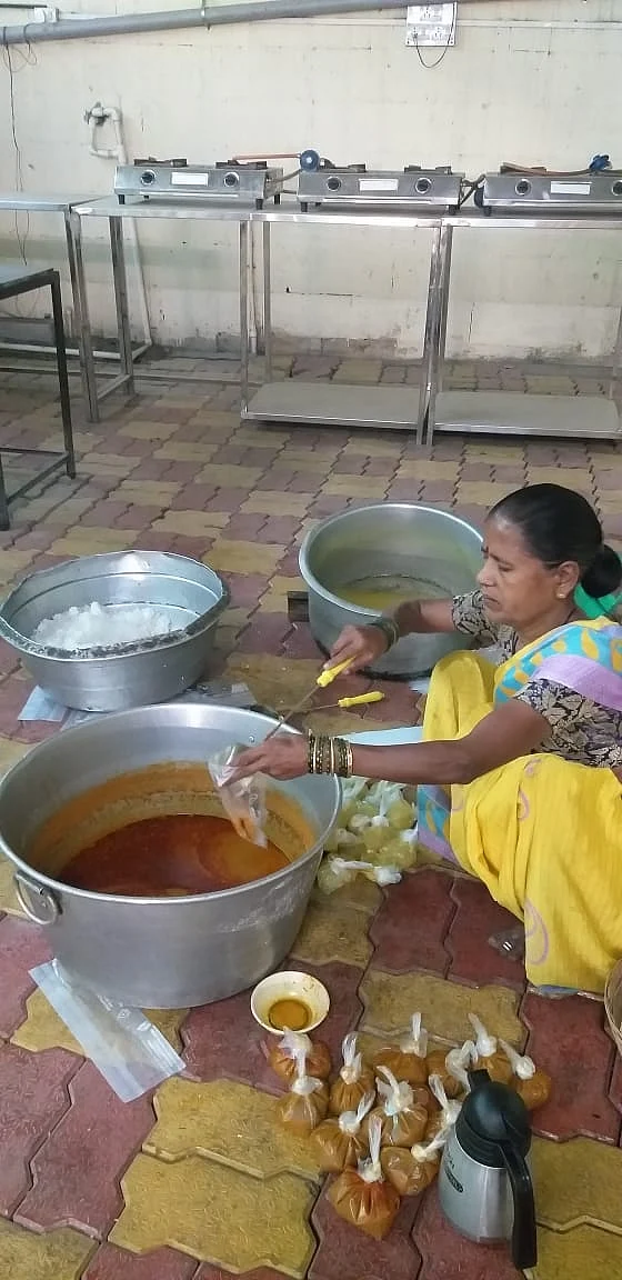 An employee packing the food parcels.