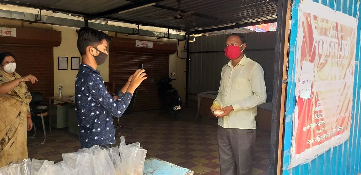 An employee clicking picture of a beneficiary.