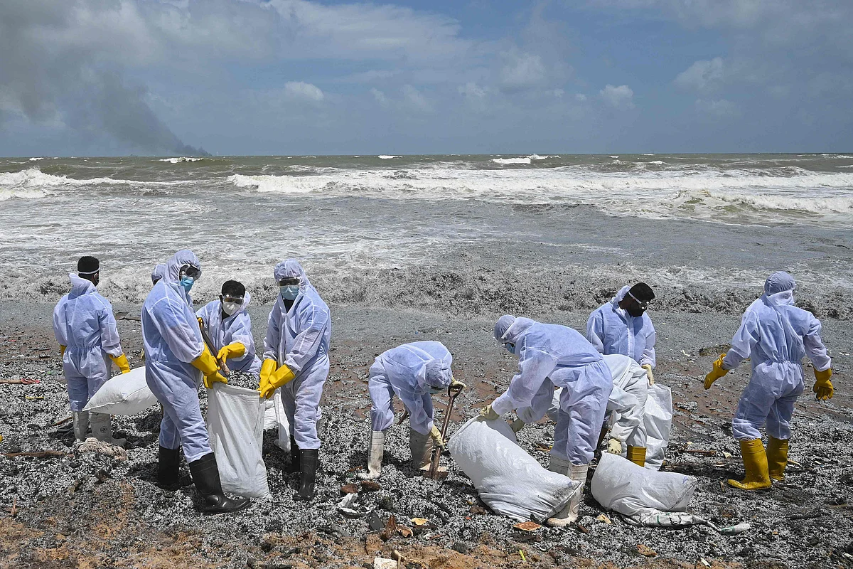 Sri Lankan Navy soldiers work to remove debris washed ashore from the Singapore-registered container ship MV X-Press Pearl, on a beach in Colombo on May 27