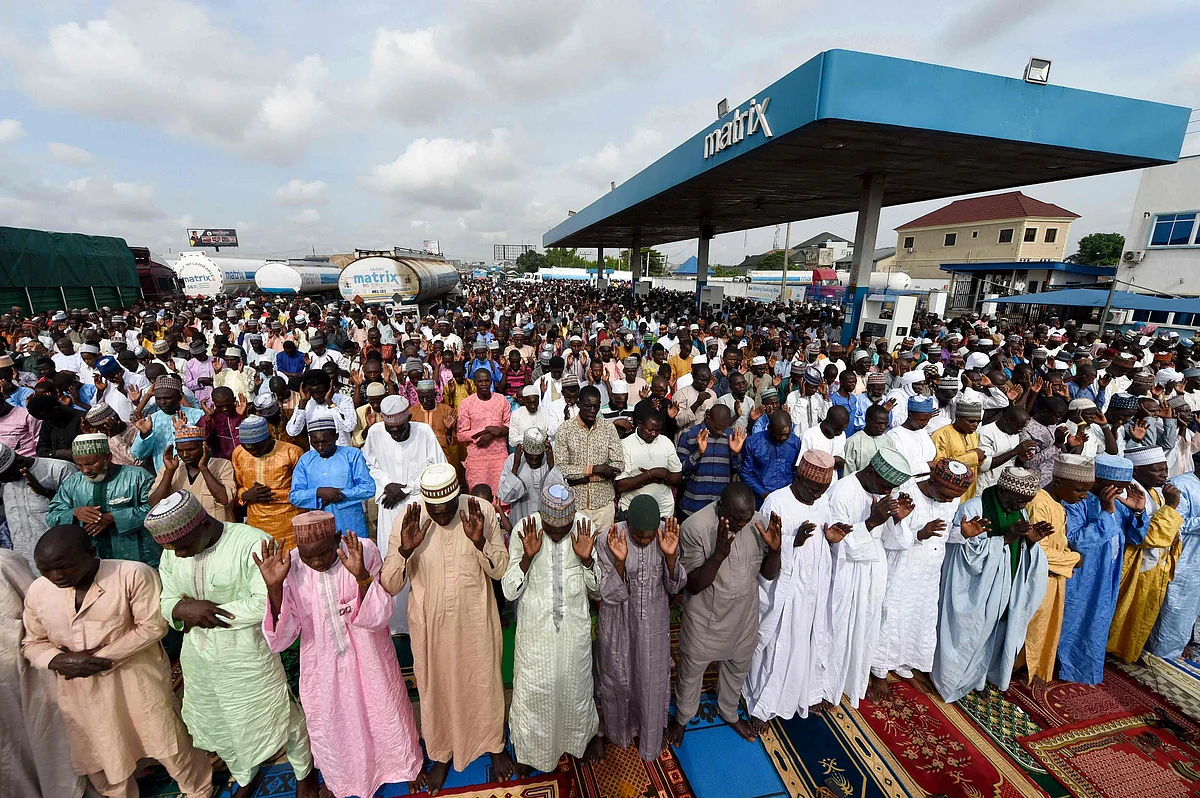 Muslim faithfuls pray at a filling station, Kara Isheri in Ogun State, southwest Nigeria, on May 13, 2021