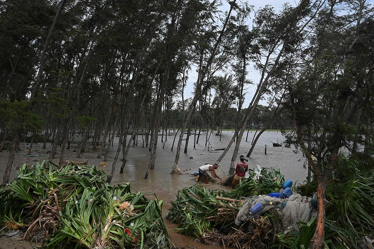 Fishermen collect damaged fishing nets after Cyclone Yaas hit Indias eastern coast in the Bay of Bengal, at a beach in Digha, some 190 km from Kolkata on May 27, 2021.