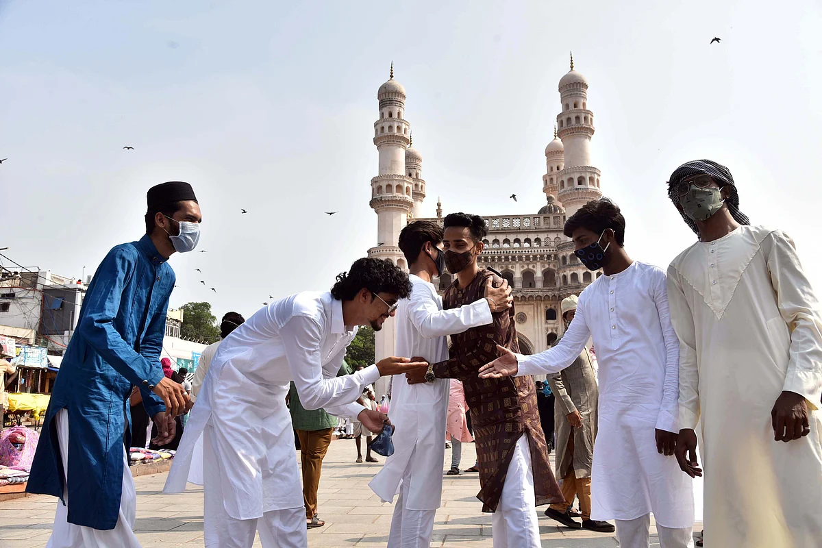 People greet each other on Eid ul-Fitr festival marking the end of the holy fasting month of Ramadan, in Hyderabad on Friday.