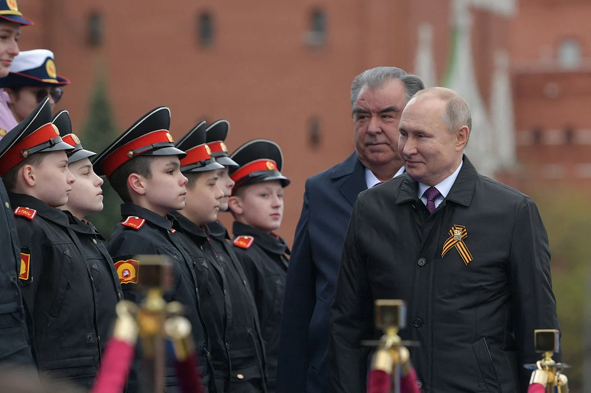 Russian President Vladimir Putin and Tajikistans President Emomali Rakhmon arrive to watch the Victory Day military parade at Red Square in Moscow on May 9, 2021.