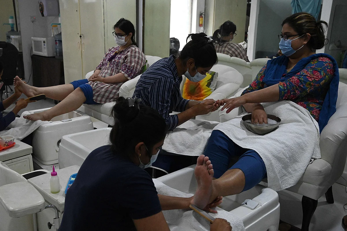 Beauticians attend customers at a beauty salon during the holy month of Ramadan ahead of the Eid ul-Fitr festivities amid the Coronavirus pandemic in Islamabad on May 10, 2021.