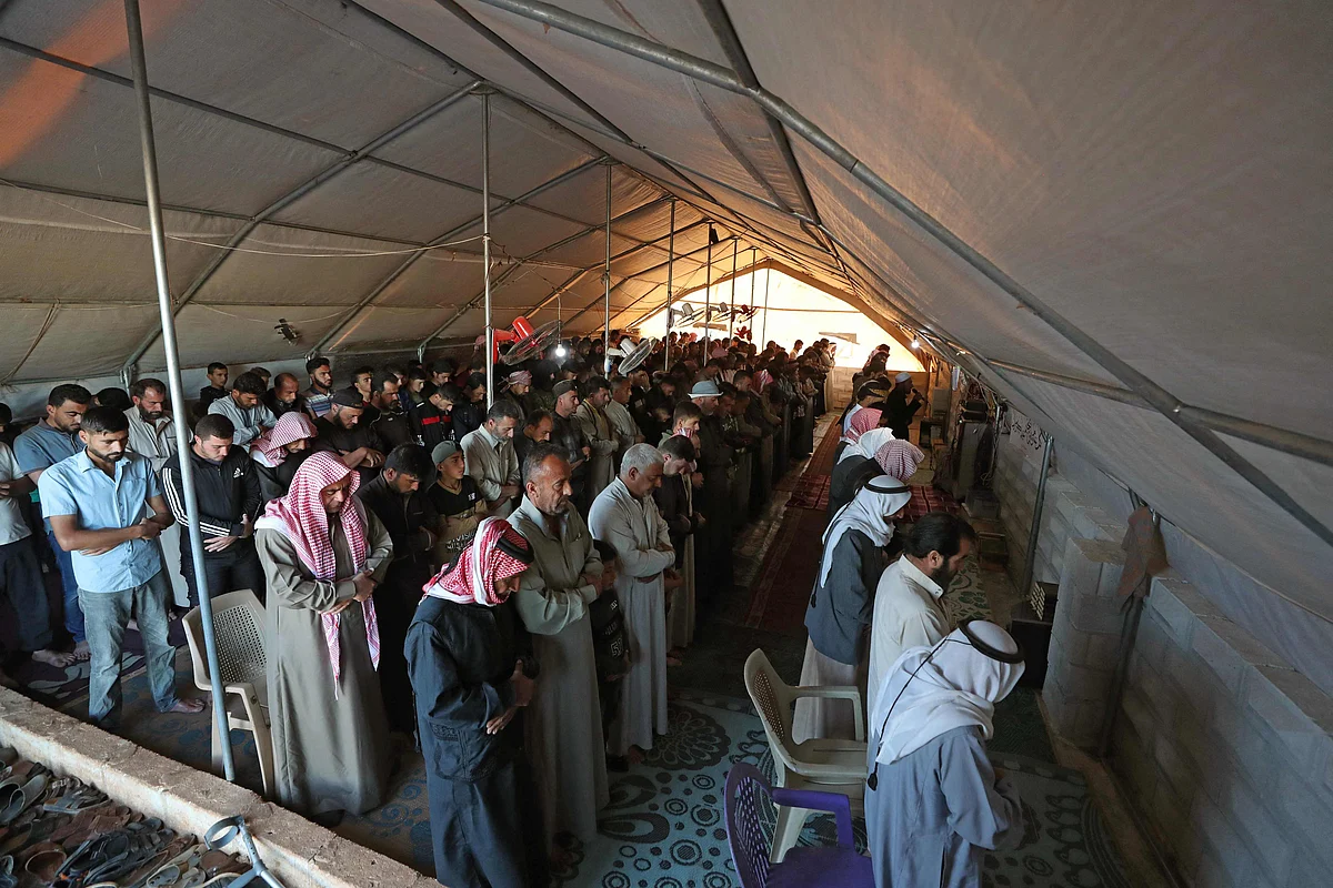 Displaced Syrians gather to pray inside a tent at the al-Tah camp for internally displaced persons (IDP) in Syrias rebel-held northwestern province of Idlib on May 13, 2021, on the first day of the Eid al-Fitr holiday, which marks the end of the holy fasting month of Ramadan.