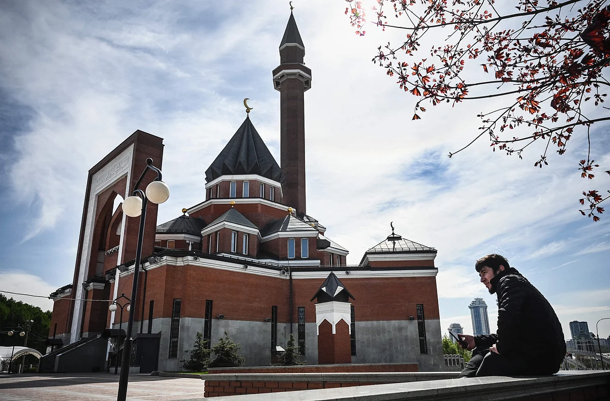 A man sits in front of a mosque at Poklonnaya Hill in Moscow on the day of the celebration of Eid al-Fitr which marks the end of the holy month of Ramadan on May 13, 2021. - The Spiritual Directorate of Muslims of the Russian Federation did not accept parishioners for Eid Namaz prayer which has been broadcasted online, due to the outbreak of COVID-19, caused by the novel coronavirus