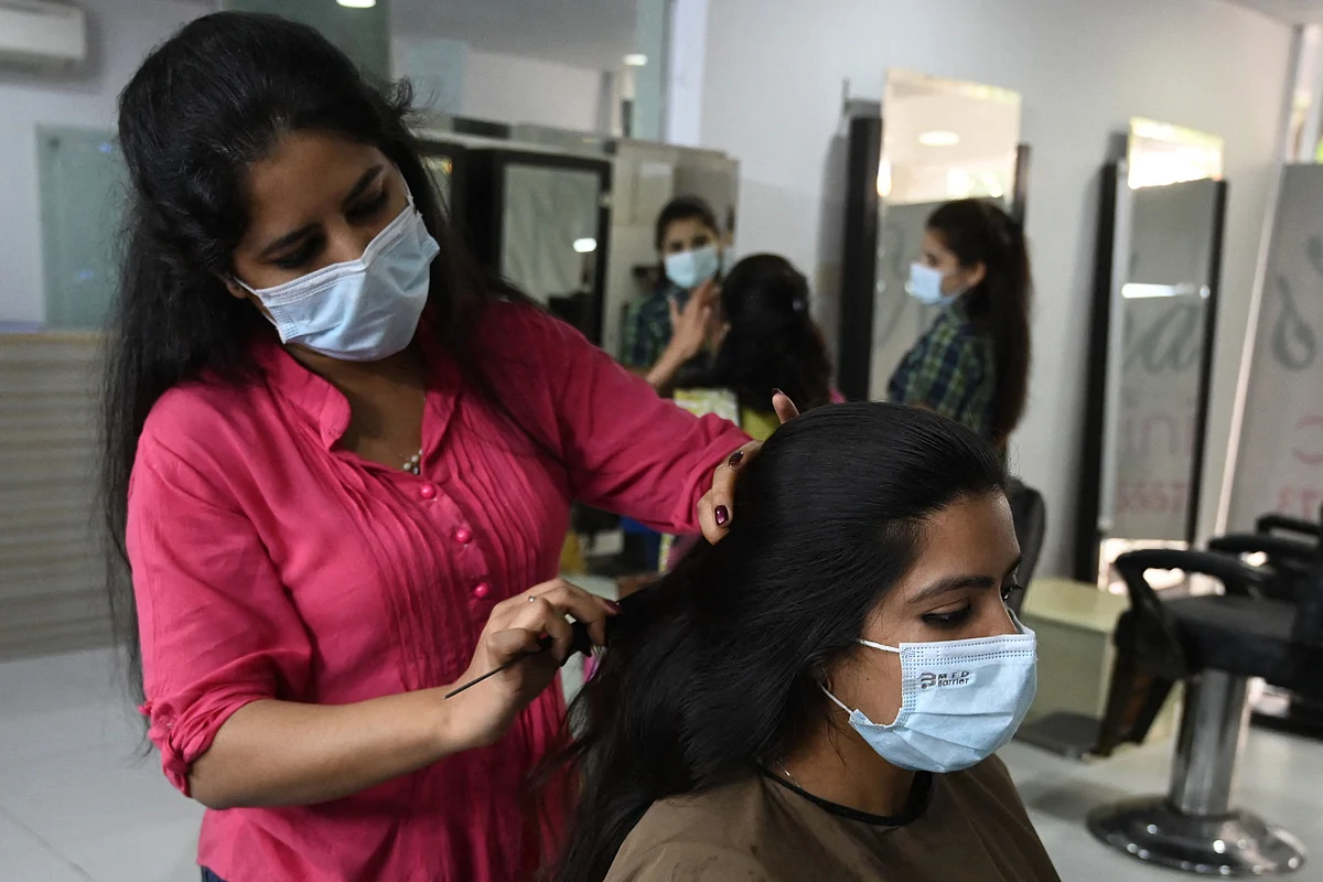 A beautician attends a customer at a beauty salon during the holy month of Ramadan ahead of the Eid al-Fitr festivities amid the Coronavirus pandemic in Islamabad on May 10, 2021.