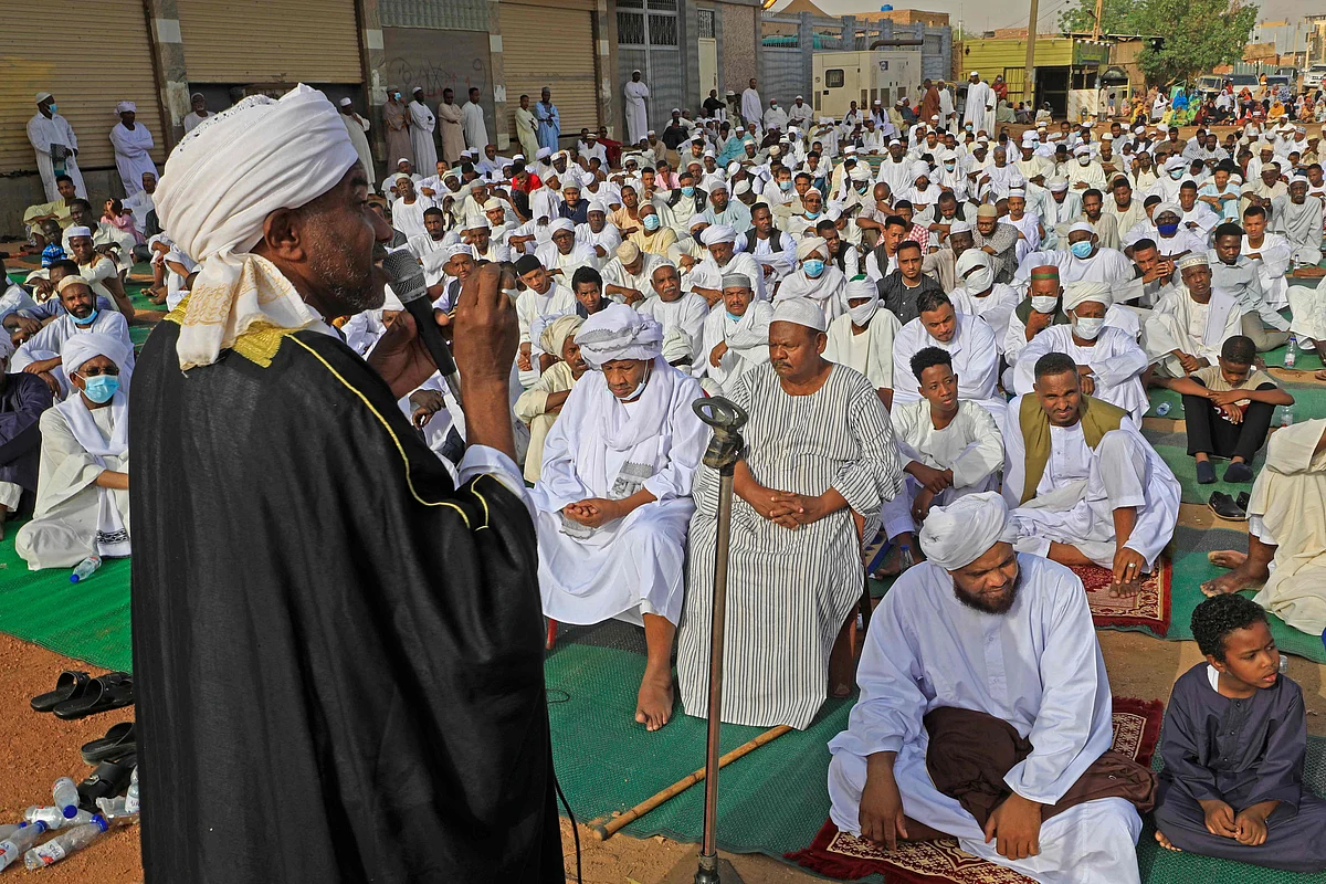 Sudanese worshippers gather to perform the Eid al-Fitr prayers in Al-Jarif, outside the capital Khartoum, on May 13, 2021.