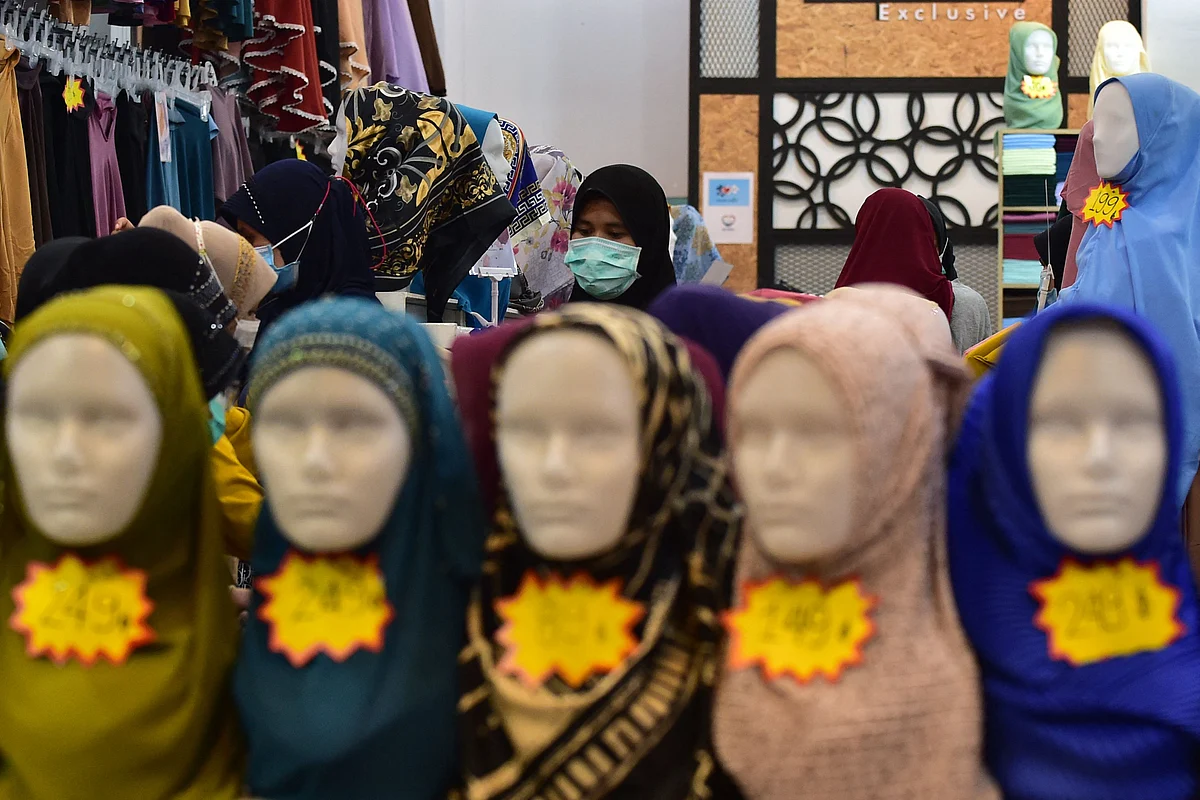 In this photo taken on May 9, 2021 a woman shops for clothes at a market amid concerns over the spread of the Coronavirus in the southern Thai province of Narathiwat, ahead of the Eid ul-Fitr festival marking the end of the Islamic holy month of Ramadan.