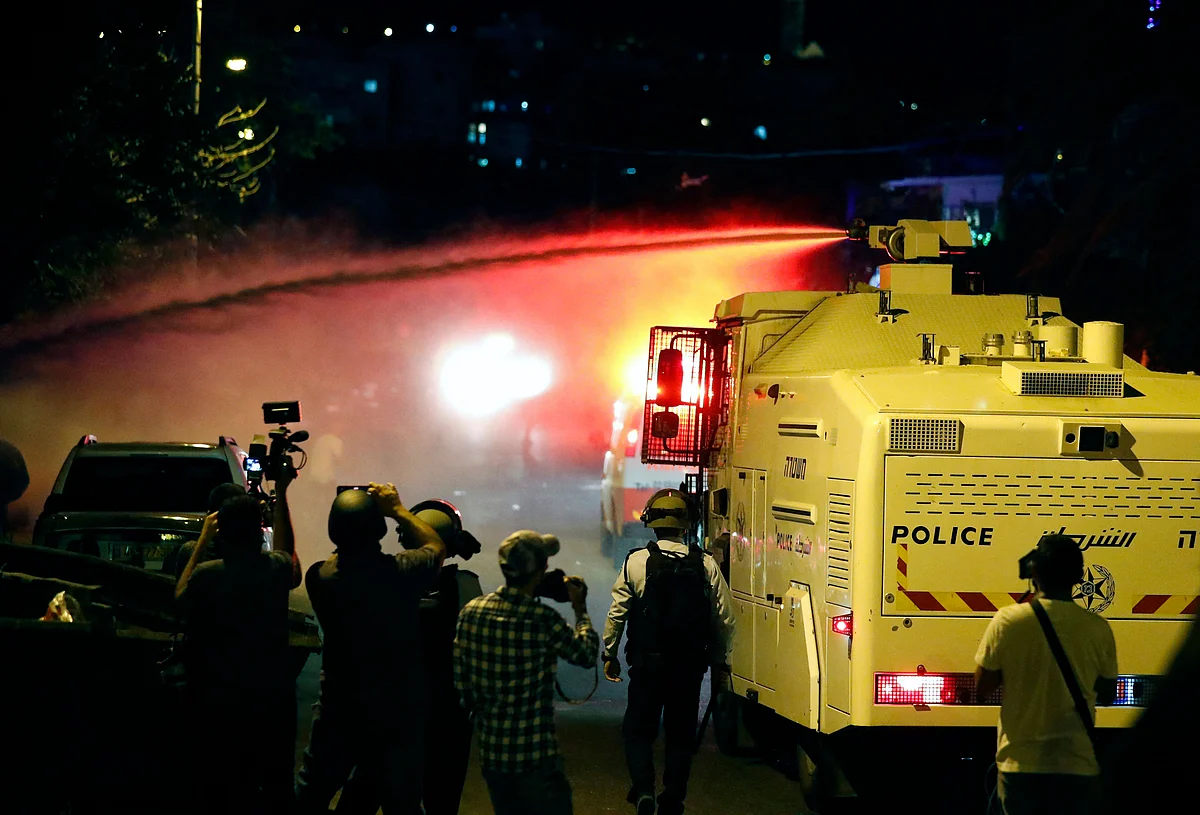 Israeli security forces spray Palestinian protesters with skunk water in the east Jerusalem neighbourhood of Sheikh Jarrah on June 21, 2021, during clashes between Israeli far-right extremists and Palestinians.