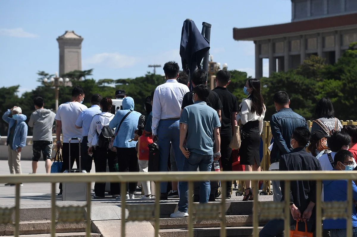 Visitors line up to have their identification documents checked before entering Tiananmen Square in Beijing on June 4, 2021, the 32nd anniversary of the deadly 1989 crackdown on pro-democracy protests.