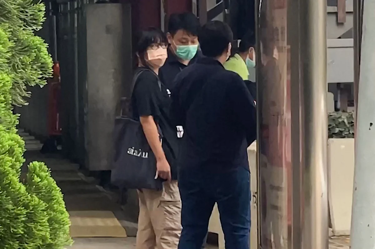 This video frame grab taken from AFPTV footage shows Chow Hang-tung (L), barrister and a leader of the Hong Kong Alliance in Support of Patriotic Democratic Movements of China, being led away by plainclothes police officers after being detained in Hong Kong on June 4, 2021, the anniversary of Beijings deadly Tiananmen crackdown.